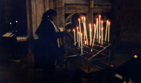 Jacqui lighting a candle inside the Cathedral, Rodez, Aveyron, France