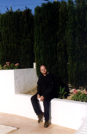 Andrew sitting by the poolside, Spain